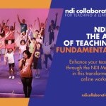 A teacher and students raise their arms above their heads.