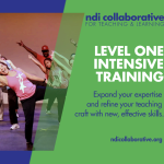 A teacher leans and reaches her arm