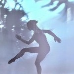 silhouette of a dancer posed in profile standing on one leg with the other in front, arms and legs bent; abstract background