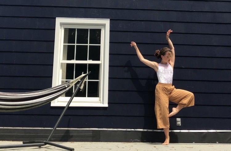 Lily Mollicone dancing outside against a house, window, hammock