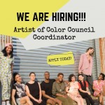 Members of the Artists of Color Council cluster together in front of an old metal fence. 