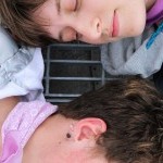 Pax  looking at Theo&rsquo;s back of head with a faint smile 