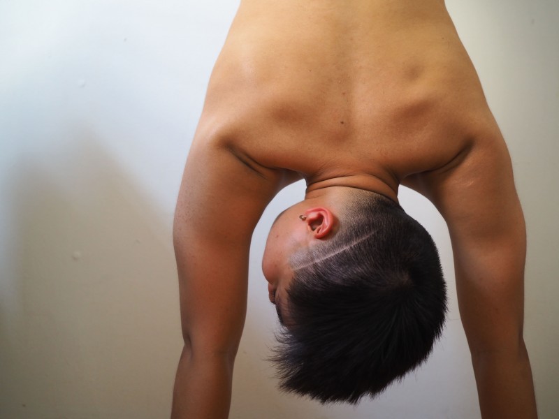 Shannon's in a handstand while shirtless