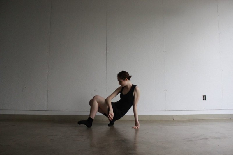 Photo of dancer posing in a squat.