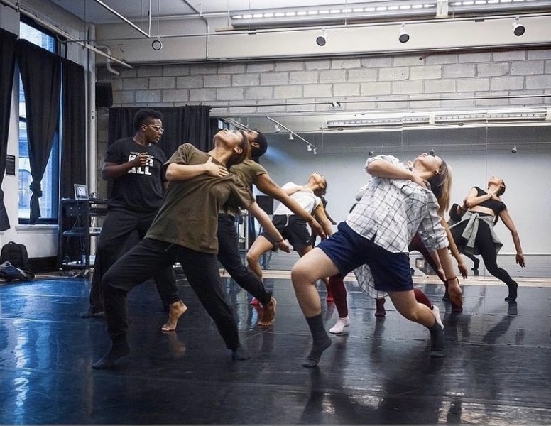 7 dancers hinge back looking up to the ceiling