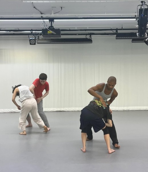 two male identifying dancers and two female identifying dancers in a white studio oin parallel duets