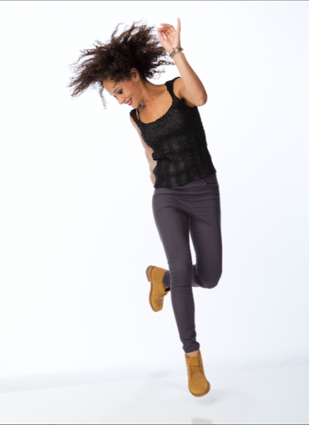Tap artist Ayodele Casel jumping off one foot with gaze turned downward