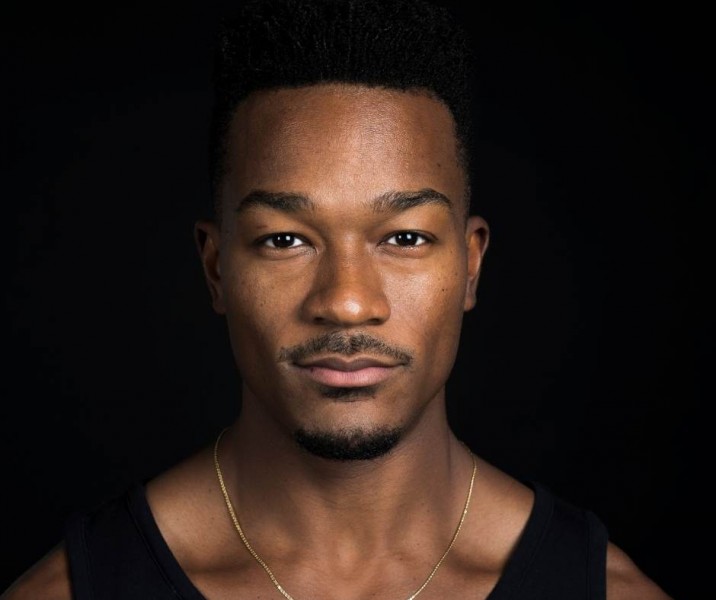 Headshot image of David Adrian Freeland, Jr, in a black tank top