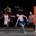Dancers of Batsheva Dance Company, front row of dancers descending to the floor while back row dancers jump