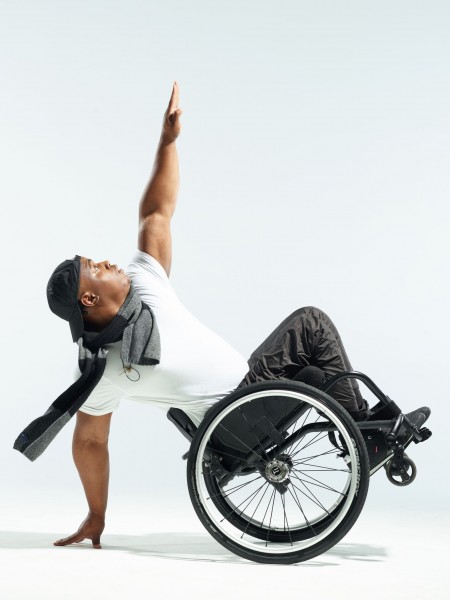 a photo of DeMarco Sleeper dancing, his wheelchair is tilted, he is balancing on one arm
