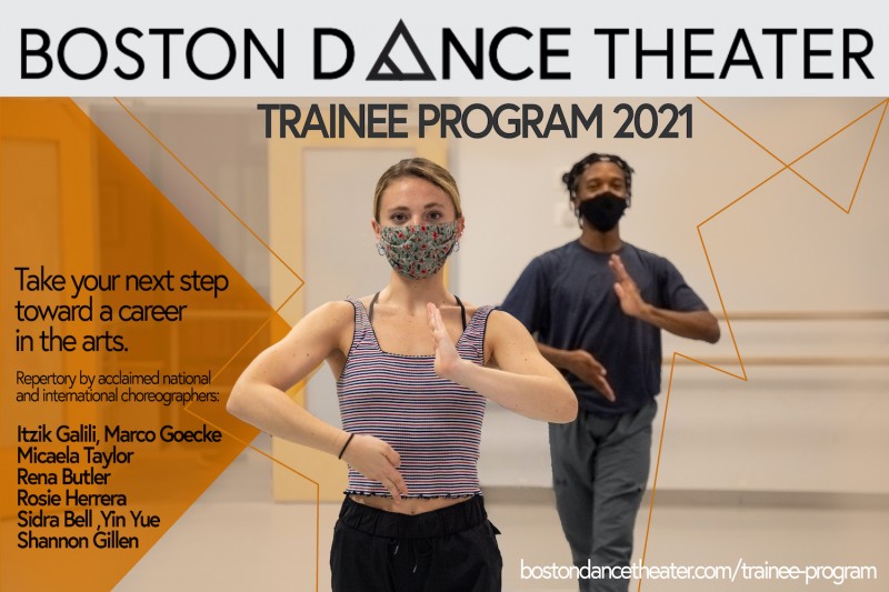 Two dancers photographed from the torso up, with their right hand pointed up and their left hand pointed downwards.