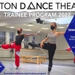 Two dancers pose with their right leg up at horizontal and their left arm extended out to the side.