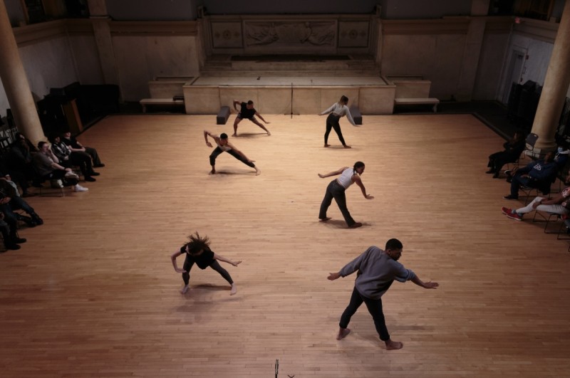 Dancers in 2 lines doing linear, staccato movements  