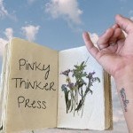 a pinky finger gestures towards a book 