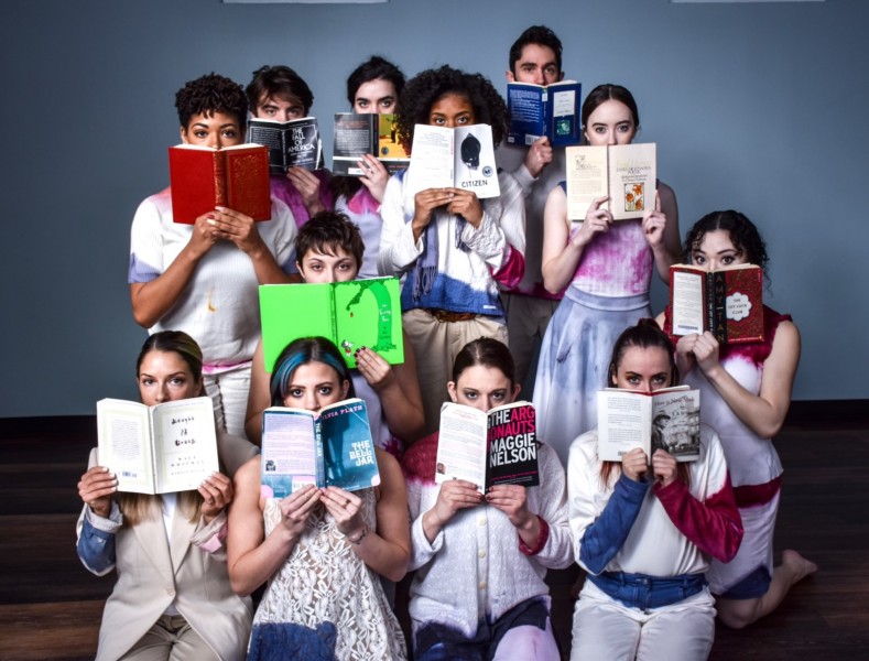 Mignolo company dancers pose while reading literature by American authors.