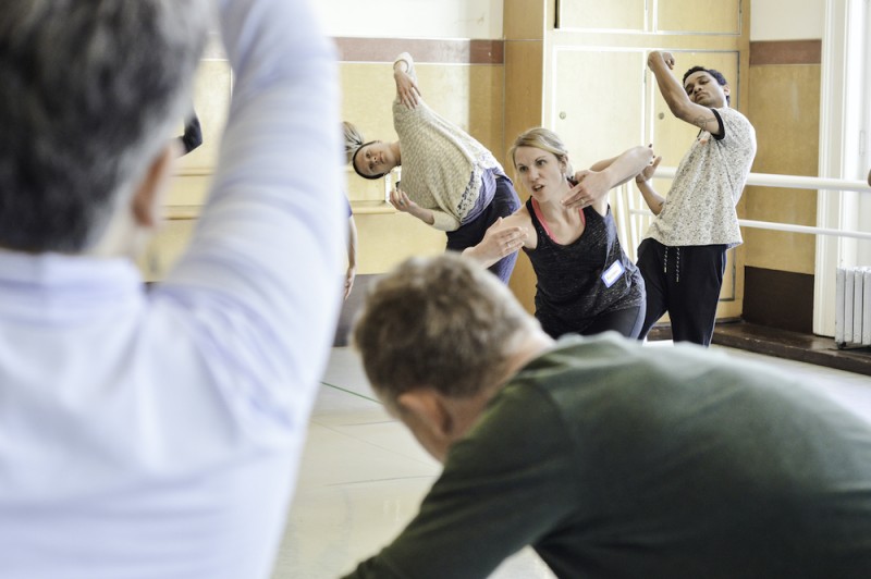 Educators in a guided movement session, exploring the use of their arms