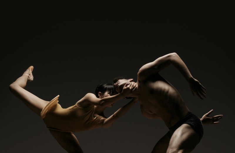 Two dancers pull apart from one another