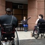 Sofia is seen teaching an outdoor seated dance class to wheelchair users. 