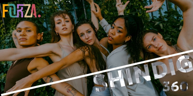 5 female dancers posing towards the camera closely infront of a green vine wall