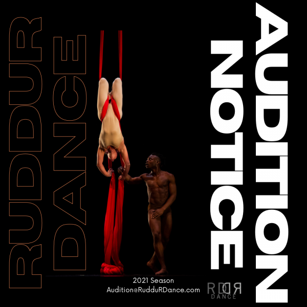 Two dancers, one upside down hanging from a red sillk 