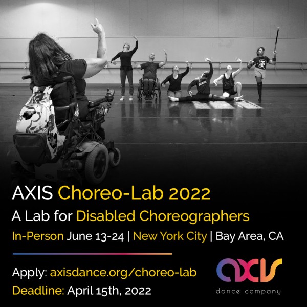 A power wheelchair user directs a group of disabled and non-disabled dancers who stand and sit in a line in a dance studio.