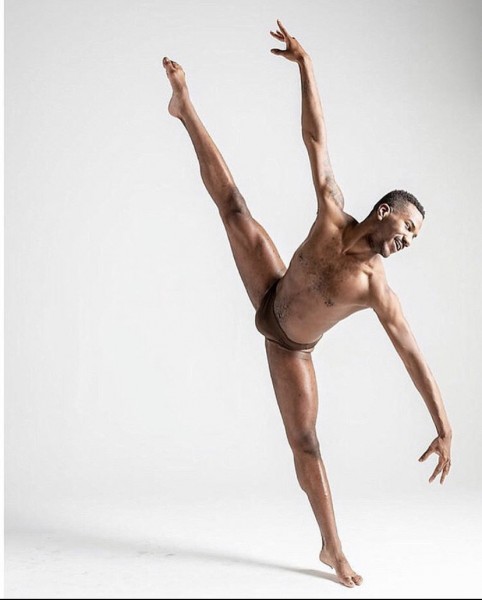 Dancer in a tilt arms reaching in opposite directions