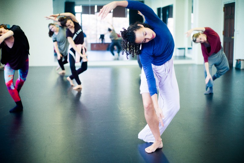Woman is blue curved in modern dance position