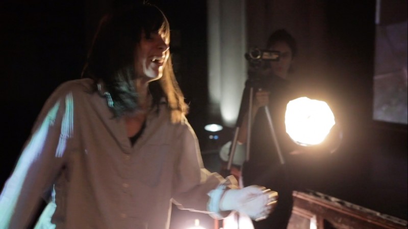 Meredith Glisson, instructor performing in front of a camera on stage.