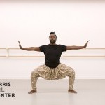 a man in plie with outstretched arms dancing in a studio