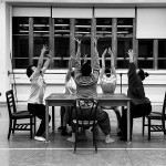five dancers dancing around a table