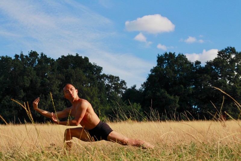 a male dancing in nature