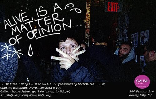 A white man holding up two peace signs with "Alive is a matter of opinion..." written in white text with stars and a teardrop