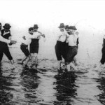 Early 20th century photograph of men dancing together in a body of water