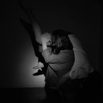 One mover supporting another mover over their shoulder. 