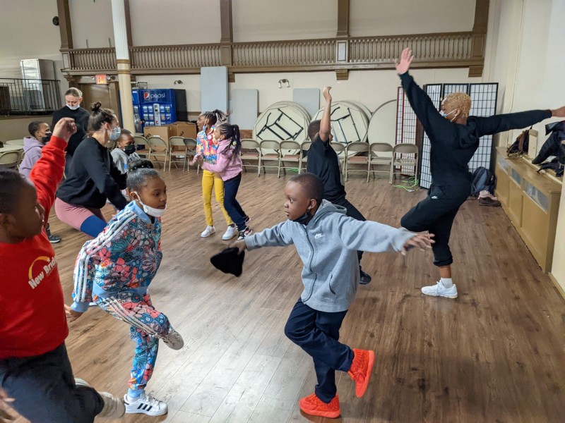 Children dancing on one foot with instructor on one foot.