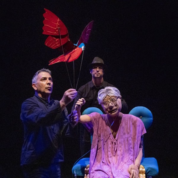 Puppeteers operate puppets on stage