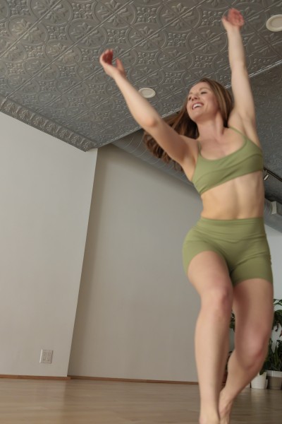 dancer is reaching to her right off camera