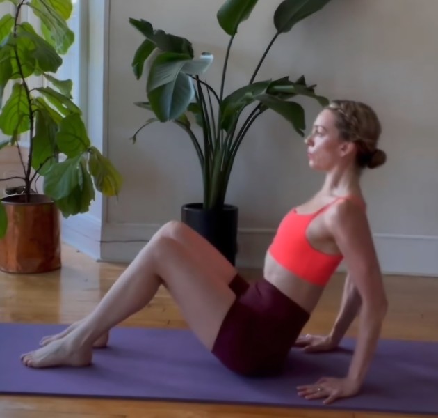 Person in a pilates position on a yoga mat