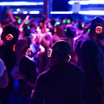 People at a Silent Disco Party dancing and wearing different colored headphones listening to music