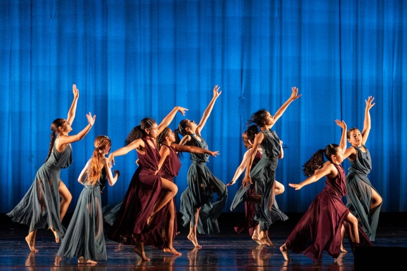 a diverse group of pre-teens in a lyrical contemporary dance with flowing burgundy and sage dresses