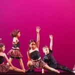 group of 5 young dancers in a jazz dance pose and wearing pink and black sequins