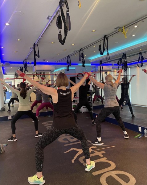 Group Class working out in a bright studio using resistance bands