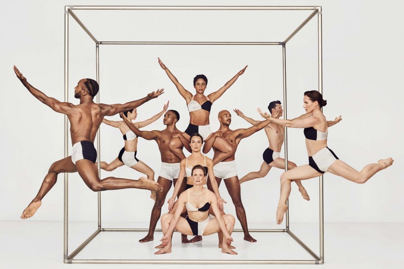 Paul Taylor dancers posed against a white backdrop. 