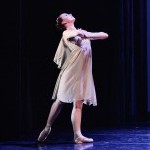 Dancer looking up. Black background. 