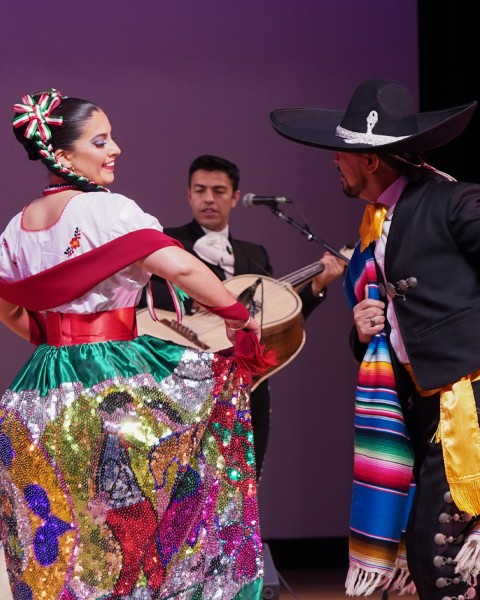 Two people dancing in traditional clothing.