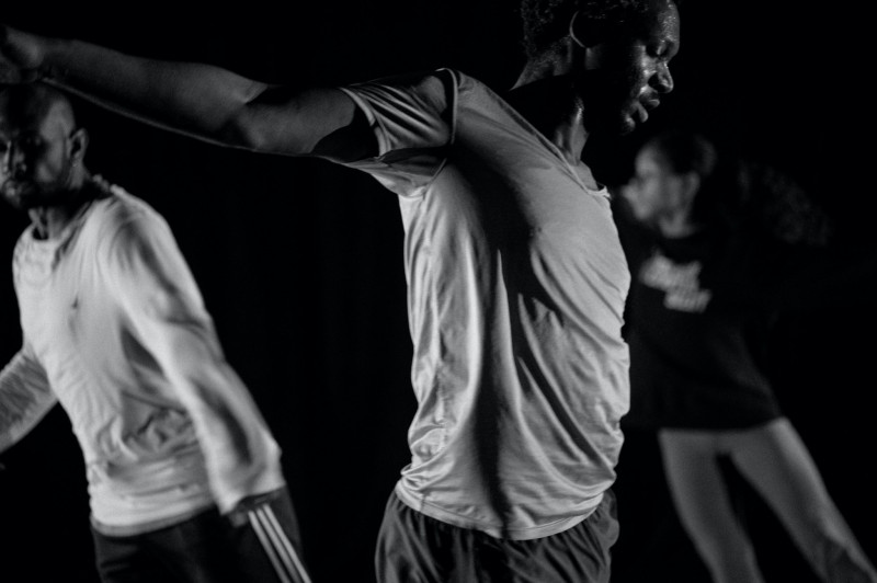 L/R: Nik Owens, Kyle Marshall, Niara Hardister // Description: Black and white image of three Black performers in rehearsal clot