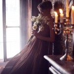 beautiful young woman in darkk romantic french ballroom