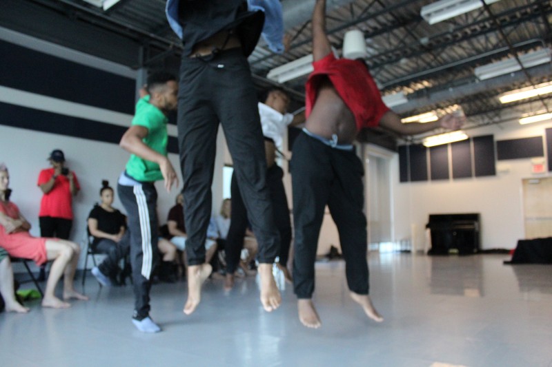 Four dancers are captured mid jump