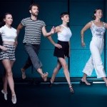 Four dancers mid-movement, as though walking on air.