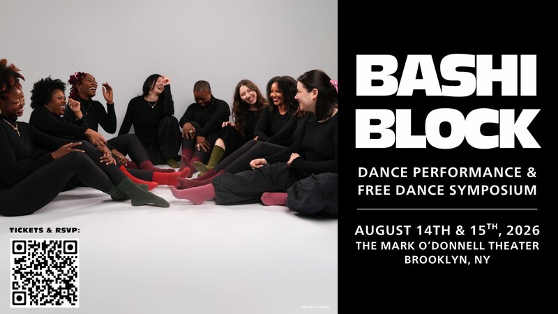 A diverse group of dancers sitting in a semi-circle formation, laughing and smiling informally.